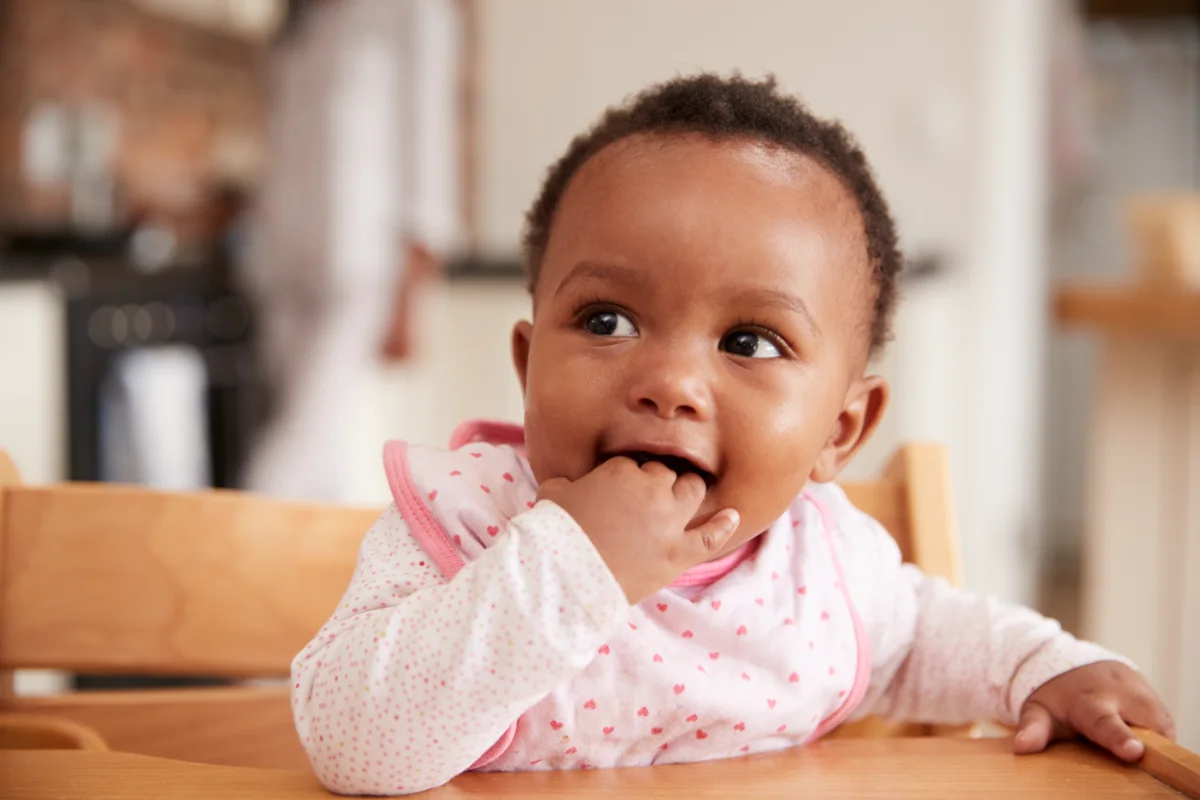 Baby sitting in high chair